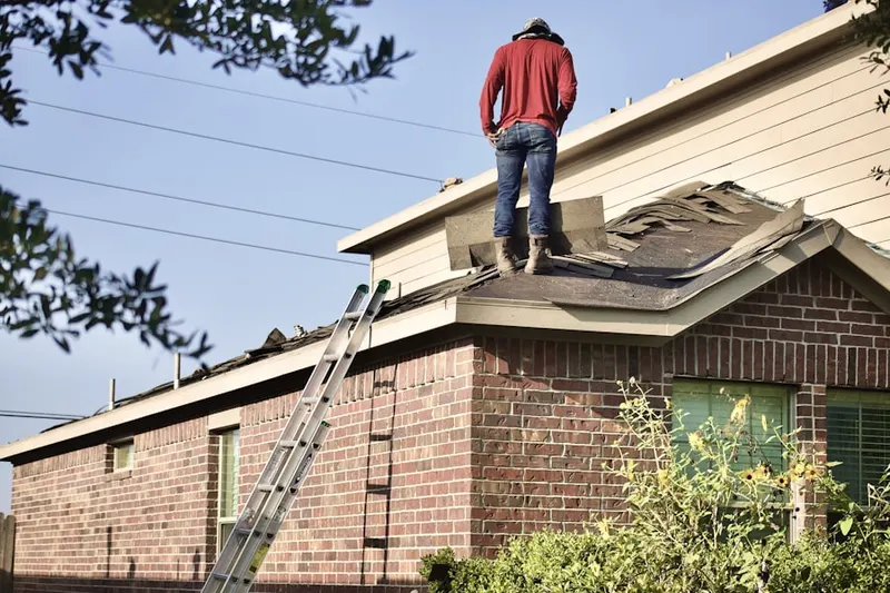 Professional roofer working on a residential roof in Salem Village